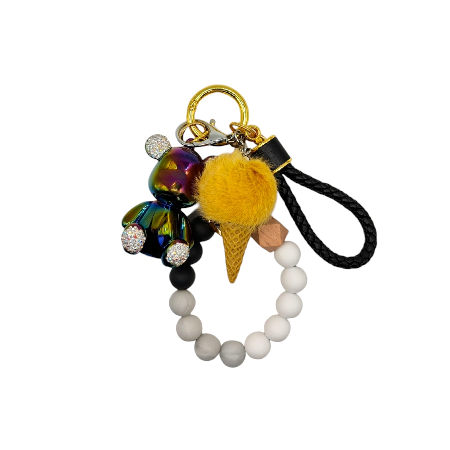 Cute and colorful ice cream-themed keychain featuring a pink pom-pom, a gold metallic teddy bear charm with diamond ears, and a beaded  black leather like strap.