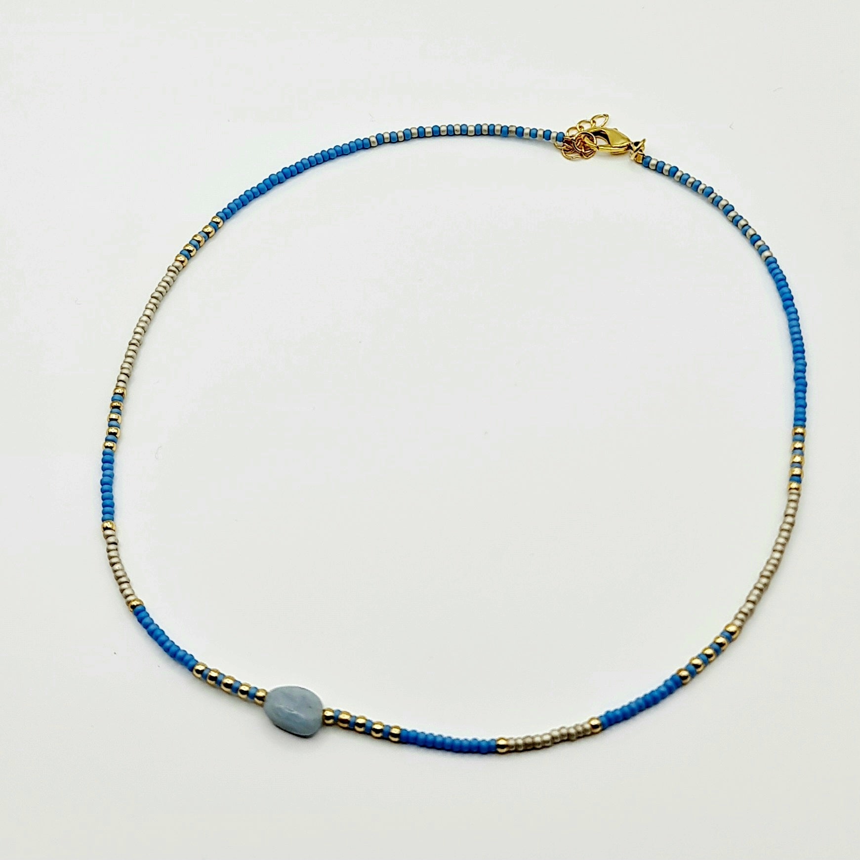 natural stone necklace, blue/gold features, side view, arcobaleno beads