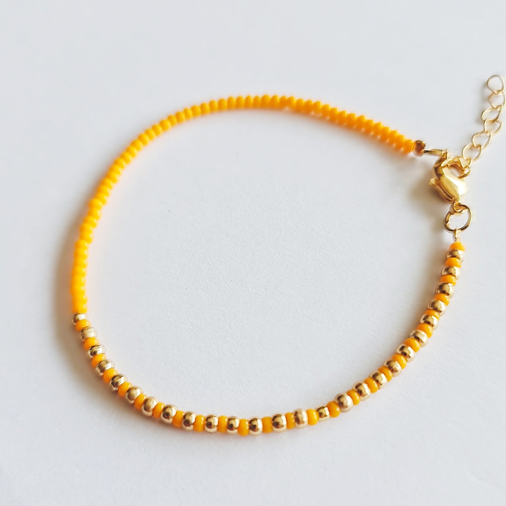 beaded bracelets, beaded jewellery, multicoloured bead bracelets, orange and gold beaded bracelet